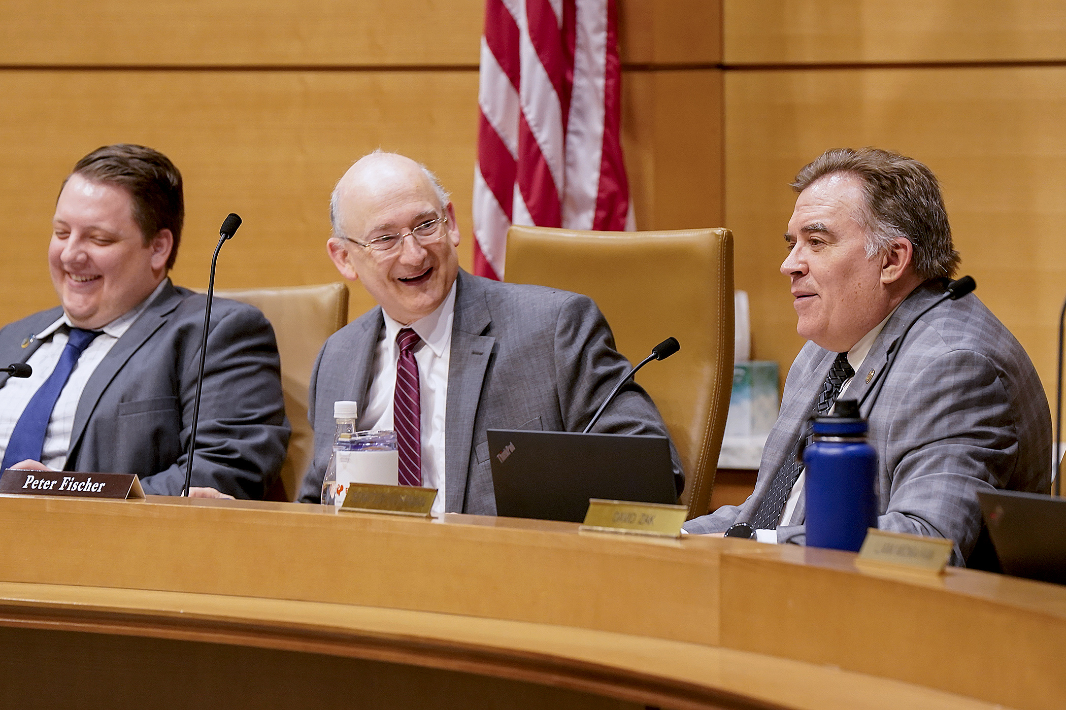 Rep. Peter Fischer, left, and Sen. John Hoffman share a light moment while hearing testimony May 2 during a meeting of the human services conference committee. (Photo by Michele Jokinen)